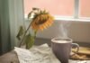 Positive Thinking Quotes to Lift Your Spirits and Elevate Your Mind Crumpled notebook with handwritten quotes, steaming coffee, and wilting sunflower on a wooden table.